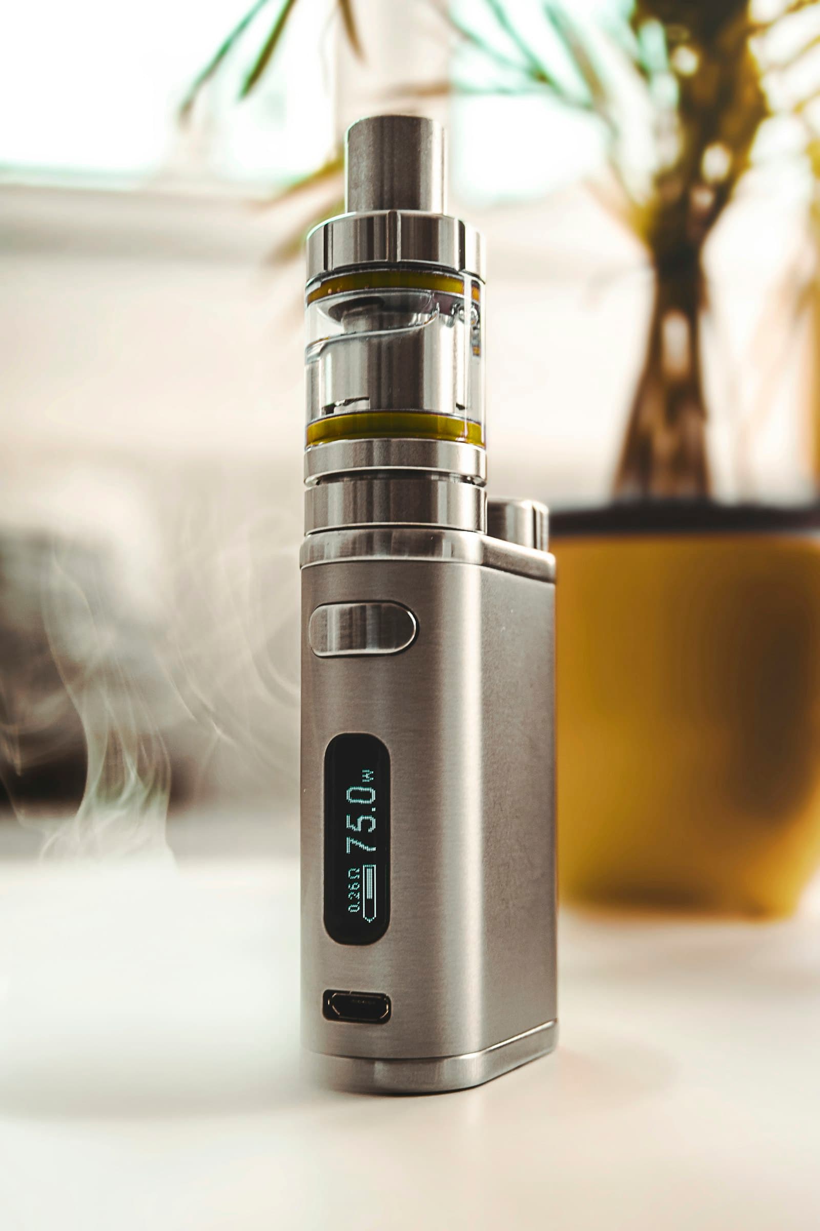 Close-up of a grey pod-system vape device showing its compact battery section